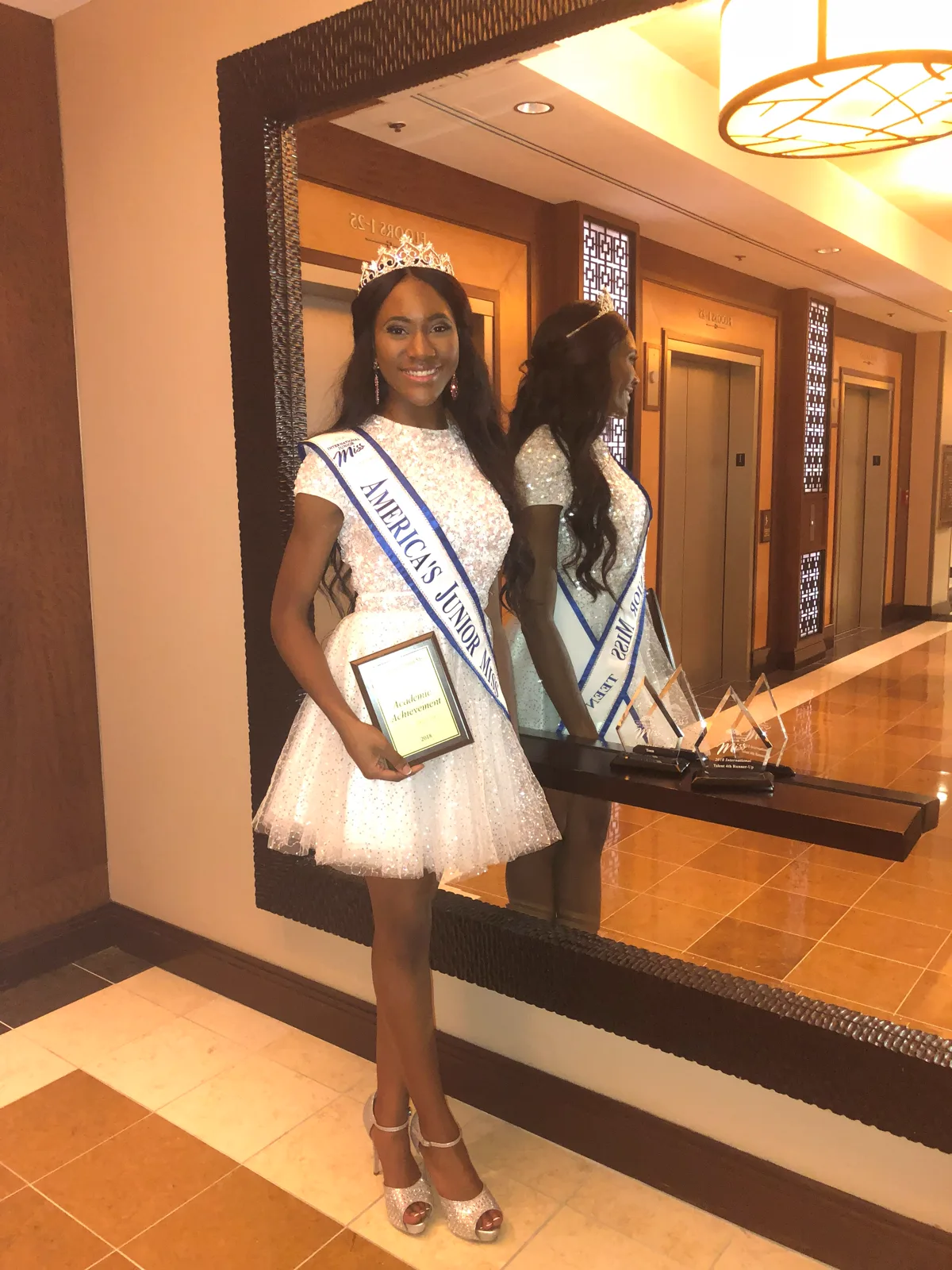 Ahdis in her America’s Junior Miss Teen sash and crown, holding her award