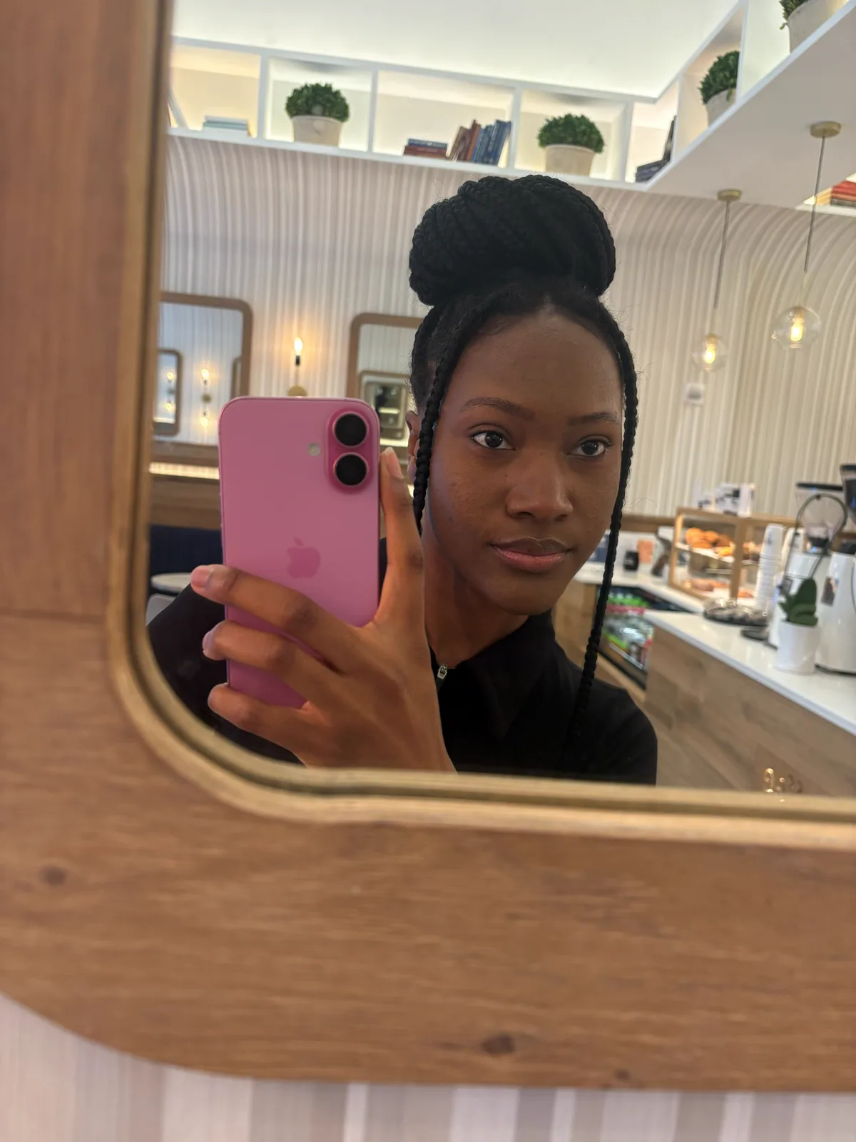 Ahdis, hair up, at a café in New York